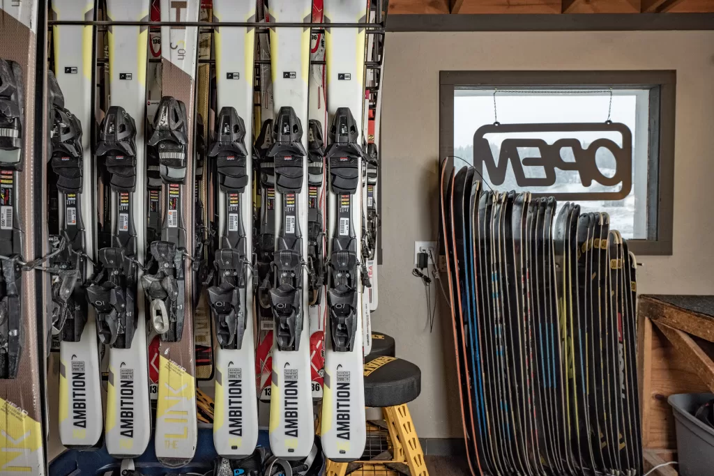 rack of snowboards and skis